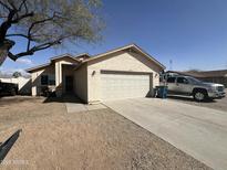 Charming single-story home featuring desert landscaping, wide driveway and a two-car garage at 1815 S San Marcos Dr, Apache Junction, AZ 85120