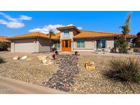 Charming single-story home with a vibrant, tiled roof and desert landscaping creating a welcoming curb appeal at 2585 Leisure World --, Mesa, AZ 85206