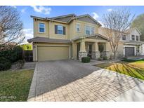 Charming two-story home featuring a two-car garage, stone accents, and a welcoming front porch at 3541 E Amber Ln, Gilbert, AZ 85296