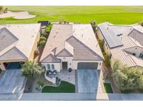 An aerial view of a single-Gathering home features a tile roof, a two-car garage, and manicured front lawn at 36518 N Crucillo Dr, Queen Creek, AZ 85140