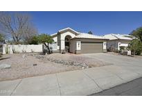 Charming single-story home with a well-manicured front yard, desert landscaping and a two-car garage at 4002 E Rockwood Dr, Phoenix, AZ 85050