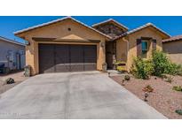 Charming single-story home featuring a manicured front yard and a two-car garage at 4332 N 197Th Dr, Litchfield Park, AZ 85340