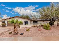 Charming single-story home with desert landscaping, palm tree, and inviting front entrance at 6036 E Windsor Ave, Scottsdale, AZ 85257