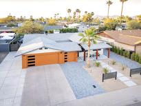 Expansive aerial view of a stylish home featuring a modern garage, desert landscaping, and mountain views at 8114 E Arlington Rd, Scottsdale, AZ 85250