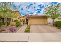 Charming single level home with a well-manicured front yard and brick paved driveway at 10156 E Radiant Ave, Mesa, AZ 85212