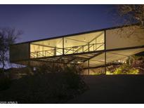 Striking modern home featuring an elevated design and expansive windows, beautifully lit at twilight at 1340 E Las Palmaritas Dr, Phoenix, AZ 85020