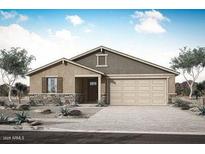 Charming single-story home featuring desert landscaping and a spacious two-car garage at 17281 W Via Dona Rd, Surprise, AZ 85387