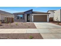 Inviting single-story home featuring a neutral color palette, two-car garage, and low-maintenance desert landscaping at 17295 W Via Dona Rd, Surprise, AZ 85387