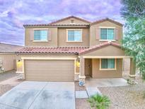 Two-story home featuring a two-car garage, neutral color palette, and a charming front entrance at 25437 W Mahoney Ave, Buckeye, AZ 85326