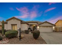 Charming single-story home with a well-manicured desert landscape and a spacious two-car garage at 25454 N 73Rd Ave, Peoria, AZ 85383