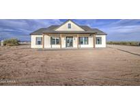 Charming single-story home featuring a welcoming front porch and modern farmhouse design in a spacious lot at 28003 N Faded Creek Dr, Florence, AZ 85132