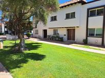 Charming townhouse featuring stucco exterior, clay roof and well-maintained green lawn at 4304 N Parkway Ave, Scottsdale, AZ 85251