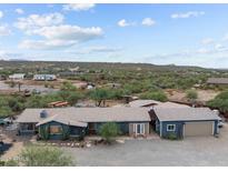 Expansive desert property showcasing a home with a large lot and garage at 49011 N 7Th Ave, New River, AZ 85087