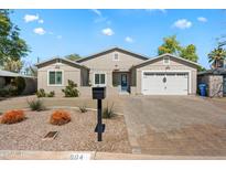 Charming single-story home featuring a two-car garage and a beautifully landscaped front yard at 804 E Palmaire Ave, Phoenix, AZ 85020