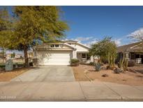 Charming single-story home with a two-car garage, xeriscaped front yard, and stone accents at 10656 E Plata Ave, Mesa, AZ 85212