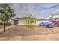 Charming single-story home with xeriscaped yard, mature trees, and a welcoming entrance at 1340 E Townley Ave, Phoenix, AZ 85020