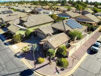 Charming home featuring tile roof, desert landscaping, solar panels, and an attached two car garage at 14385 W Morning Star Trl, Surprise, AZ 85374