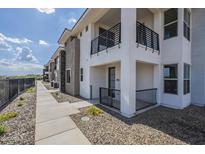 Modern townhome featuring a private balcony and landscaped front yard, perfect for outdoor enjoyment at 2121 W Sonoran Desert Dr # 93, Phoenix, AZ 85085