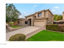 Charming two-story home with a well-manicured lawn and a spacious driveway at 25622 N Singbush Loop, Phoenix, AZ 85083