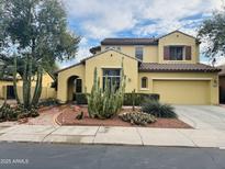 Two-story home with desert landscaping, a tile roof, and an attached two-car garage at 3325 E Grand Canyon Dr, Chandler, AZ 85249