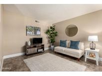Cozy living room with neutral decor, a plush sofa, stylish furnishings and plenty of sunlight at 3511 E Baseline Rd # 1076, Phoenix, AZ 85042