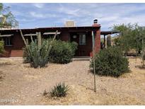 Charming single-story home with a desert-landscaped front yard and rustic accents at 37448 N 301St Ave, Wittmann, AZ 85361