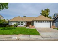 Charming single Gathering home with a well manicured lawn, attached garage, and quaint brick accents at 1120 W Barrow Dr, Chandler, AZ 85224
