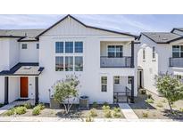 Stylish two-story home featuring a balcony, large windows, and modern architectural details at 11300 N Casa Dega Dr # 1006, Surprise, AZ 85388