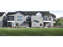 Newly built townhome with a modern exterior, lush front lawn, and manicured landscaping at 11300 N Casa Dega Dr # 1006, Surprise, AZ 85388