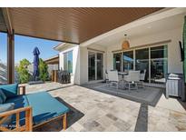 Spacious covered patio with seating, dining area, and outdoor amenities, perfect for entertaining at 12047 E Sereno Rd, Gold Canyon, AZ 85118