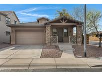 Charming single-Gathering home featuring a covered porch with stone accents and a two-car garage at 1473 W Flamingo Dr, Chandler, AZ 85286