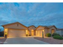Charming single-story home featuring a three-car garage and well-manicured desert landscaping at 15290 W Ventura St, Surprise, AZ 85379
