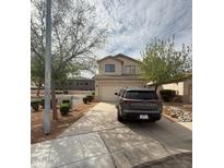 Two story house with a two car garage, landscaped yard, and a gray Pathfinder parked in the driveway at 2102 N Garrett Dr, Chandler, AZ 85225