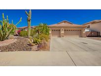 Charming single-story home with a well-maintained desert landscape and a spacious three-car garage at 26991 N 97Th Ln, Peoria, AZ 85383