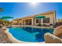 Sparkling pool and landscaped backyard create a private oasis perfect for outdoor enjoyment and relaxation at 26991 N 97Th Ln, Peoria, AZ 85383