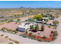 Expansive desert property with a modern stucco home and ample outdoor space, perfect for nature lovers at 30917 N 163Rd Dr, Surprise, AZ 85387