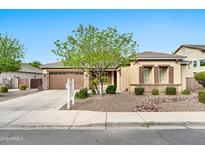 Charming single-story home with a well-manicured front yard and beautiful desert landscaping in a desirable neighborhood at 3220 N 136Th Dr, Avondale, AZ 85392