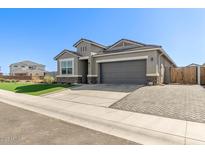Charming single-story home featuring a well-manicured lawn, a two-car garage and neutral color palette at 36708 N Petra Dr, San Tan Valley, AZ 85143