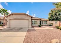 Charming single-story home featuring a two-car garage, desert landscaping, and a welcoming facade at 3721 E Colonial E Dr, Chandler, AZ 85249