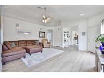Inviting living room featuring a comfortable sectional sofa, ceiling fan, and stylish decor at 3925 W Hackamore Dr, Phoenix, AZ 85083