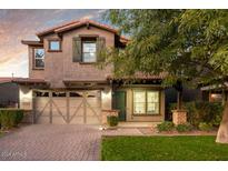 Charming two-story home featuring a paved driveway and a well-manicured lawn at 4084 E Rawhide St, Gilbert, AZ 85296