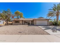 Charming single-story home featuring a two-car garage, desert landscaping and mature trees at 4533 S Terrace Rd, Tempe, AZ 85282