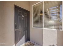 Inviting front entrance features a modern door with digital lock and large window, creating a warm and secure welcome at 7009 E Acoma Dr # 1044, Scottsdale, AZ 85254