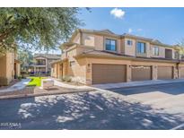 A tan two-story townhome with a two-car garage and low-maintenance landscaping at 705 W Queen Creek Rd # 2158, Chandler, AZ 85248