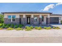 Charming home showcasing stone accents, a welcoming front porch, and manicured landscaping for curb appeal at 11188 N Blakely St, Surprise, AZ 85388