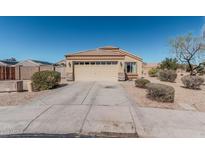 Charming single-story home with a neutral color scheme, desert landscaping, and a two-car garage at 14822 N Tonya Cir, El Mirage, AZ 85335