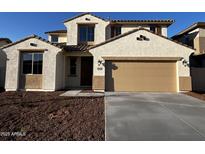 Inviting two-story home featuring a tan stucco exterior, brown tile roof, and a spacious two-car garage at 17558 W Lupine Ave, Goodyear, AZ 85338