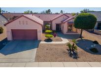 Charming single-story home with a well-maintained front yard, neutral color palette, and a two-car garage at 20047 N Shadow Mountain Dr, Surprise, AZ 85374