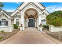 Elegant home entrance featuring a grand archway and decorative planters at 3120 E Waterman Ct, Gilbert, AZ 85297