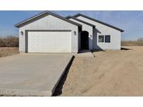 Charming single-Gathering home featuring a stucco exterior, a two-car garage and desert landscaping at 4240 N Arizona Rd, Eloy, AZ 85131